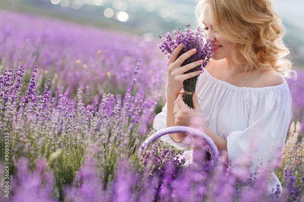 Lavender field with a woman enjoying the smell of fresh lavender